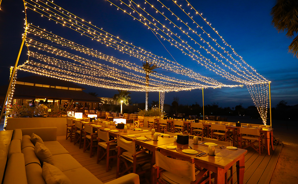 Outdoor dining area with string lights at night