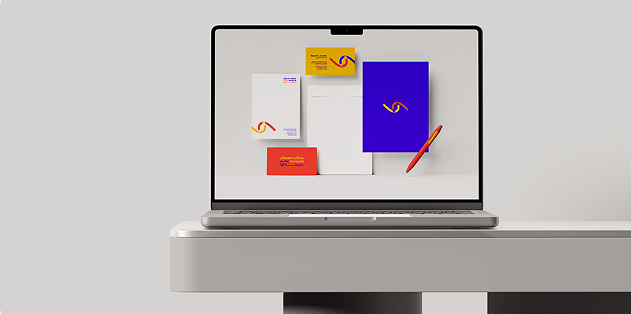 A laptop displays branding materials